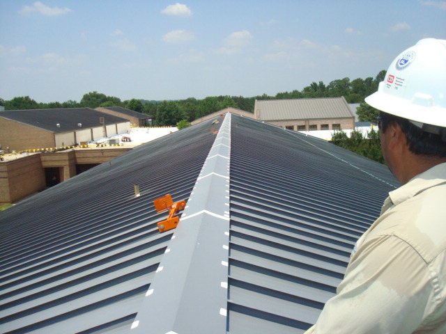 Medlock-Bridge-Man-on-Roof Public School Metal Roof Restoration – Georgia